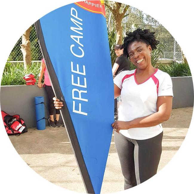 A lady smiling with a free camp flag